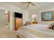 Comfortable bedroom with ensuite, TV, ceiling fan, and a decorative quilt at 10960 E Monte Ave # 169, Mesa, AZ 85209