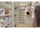 Organized walk-in closet with shelving, hanging racks, and storage baskets at 10960 E Monte Ave # 169, Mesa, AZ 85209