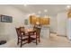 Dining area adjacent to kitchen has round table and seating for four at 10960 E Monte Ave # 169, Mesa, AZ 85209
