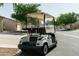White golf cart showing rear seating area, parked on the street in a suburban neighborhood at 10960 E Monte Ave # 169, Mesa, AZ 85209
