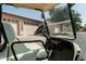 View from inside a golf cart showing steering wheel, seat, and suburban street at 10960 E Monte Ave # 169, Mesa, AZ 85209