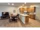Modern kitchen with granite countertops, wooden cabinets, white appliances and dining area for four at 10960 E Monte Ave # 169, Mesa, AZ 85209