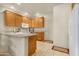 Kitchen with oak cabinets, white appliances, and granite countertops at 10960 E Monte Ave # 169, Mesa, AZ 85209