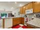 Bright kitchen with oak cabinets, white appliances, and granite countertops at 10960 E Monte Ave # 169, Mesa, AZ 85209