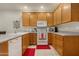 Kitchen featuring oak cabinets and white appliances at 10960 E Monte Ave # 169, Mesa, AZ 85209