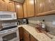Close-up of kitchen showcasing granite counters, stylish lighting, and stainless steel appliances at 10960 E Monte Ave # 169, Mesa, AZ 85209