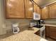 Bright kitchen with wooden cabinets, granite countertops, and modern white appliances at 10960 E Monte Ave # 169, Mesa, AZ 85209