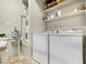 Bright laundry room with washer, dryer, shelving, and storage for organization and efficient cleaning at 10960 E Monte Ave # 169, Mesa, AZ 85209