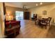 Inviting living room featuring a comfortable red sofa and a dining table, perfect for entertaining at 10960 E Monte Ave # 169, Mesa, AZ 85209