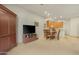 Open-concept living room with dining area and kitchen, featuring carpet floors and wood cabinets at 10960 E Monte Ave # 169, Mesa, AZ 85209