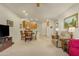 Open-concept living area with a dining table, leading to a bright kitchen at 10960 E Monte Ave # 169, Mesa, AZ 85209