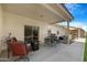 A cozy covered patio with comfortable seating and grill, ideal for outdoor entertaining and dining at 10960 E Monte Ave # 169, Mesa, AZ 85209