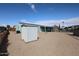 Exterior view of the property with a gravel yard, shed, and covered patio in a quiet community at 11275 N 99Th Ave # 170, Peoria, AZ 85345