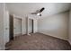 Bedroom featuring neutral walls, carpeted floor, ceiling fan, and closet at 11275 N 99Th Ave # 170, Peoria, AZ 85345
