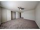 Large bedroom with carpet, ceiling fan, and roomy closet with bi-fold doors at 11275 N 99Th Ave # 170, Peoria, AZ 85345