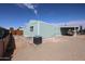 Exterior view of the home with a gravel yard and covered parking area at 11275 N 99Th Ave # 170, Peoria, AZ 85345