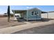 Charming exterior featuring a covered parking area, desert landscaping, and freshly painted facade at 11275 N 99Th Ave # 170, Peoria, AZ 85345
