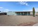 Charming light-green home featuring a large covered patio, gravel yard, and tall saguaro cactus at 11275 N 99Th Ave # 170, Peoria, AZ 85345