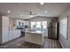 Modern kitchen featuring island with stainless steel sink, quartz countertops, and gray wood-style flooring at 11275 N 99Th Ave # 170, Peoria, AZ 85345