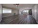 Open living space featuring wood-look floors, modern ceiling fan, and a glimpse into the updated kitchen at 11275 N 99Th Ave # 170, Peoria, AZ 85345