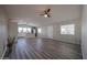 Open-concept living space with wood-style flooring, open layout, ceiling fan, and lots of light at 11275 N 99Th Ave # 170, Peoria, AZ 85345