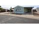 Street view of a quaint light-green home with carports and desert landscaping at 11275 N 99Th Ave # 170, Peoria, AZ 85345