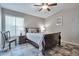 Comfortable bedroom featuring a ceiling fan and a queen-size bed with decorative pillows at 11540 W Sonoran Ct, Surprise, AZ 85378