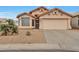 Charming single-story home featuring a well-maintained yard and a two-car garage at 11540 W Sonoran Ct, Surprise, AZ 85378