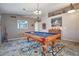 Comfortable game room featuring a pool table, carpet, and ample lighting at 11540 W Sonoran Ct, Surprise, AZ 85378