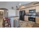 Contemporary kitchen with stainless steel appliances, granite countertops, and a center island at 11540 W Sonoran Ct, Surprise, AZ 85378
