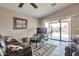 Cozy living room with vaulted ceilings, a fireplace and sliding doors to the pool area at 11540 W Sonoran Ct, Surprise, AZ 85378