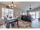 Open-concept living room with dining area and access to the outdoor patio at 11540 W Sonoran Ct, Surprise, AZ 85378