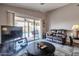 Comfortable seating in living room features an entertainment center and access to the pool at 11540 W Sonoran Ct, Surprise, AZ 85378