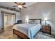 Bedroom featuring a ceiling fan, with open doorway to private lounge seating and laundry area at 11540 W Sonoran Ct, Surprise, AZ 85378
