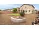 Backyard featuring gravel, a small grass patch, fire pit and the exterior of the house at 11737 W Robin Dr, Sun City, AZ 85373