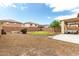 Well-maintained backyard featuring gravel, patio seating and a neat patch of green grass at 11737 W Robin Dr, Sun City, AZ 85373