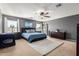 Comfortable bedroom with ceiling fan, ample natural light, and stylish furnishings for relaxation at 11737 W Robin Dr, Sun City, AZ 85373