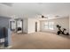 Expansive bonus room offers versatile space with ample natural light and room for fitness equipment at 11737 W Robin Dr, Sun City, AZ 85373