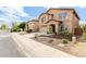 Well-manicured two-story home featuring a large driveway and an attached two-car garage at 11737 W Robin Dr, Sun City, AZ 85373