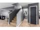 Inviting hallway with staircase and access to the bathroom, showcasing the home's layout at 11737 W Robin Dr, Sun City, AZ 85373