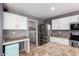 Functional kitchen featuring stainless steel fridge and access to the laundry room at 11737 W Robin Dr, Sun City, AZ 85373