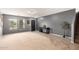 Spacious living room with a large window, neutral colors, and tile/carpet flooring at 11737 W Robin Dr, Sun City, AZ 85373
