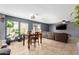 Open concept living room with large windows, wood table set, and comfortable seating area at 11737 W Robin Dr, Sun City, AZ 85373