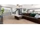 Bright and airy living room features a large sofa, open to the kitchen, and neutral color palette at 11737 W Robin Dr, Sun City, AZ 85373