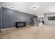 Spacious living room with a console table, cat tree, neutral carpet, and gray walls at 11737 W Robin Dr, Sun City, AZ 85373