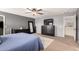 Relaxing main bedroom with ceiling fan, plush carpet, and dark-colored dresser with a mounted TV at 11737 W Robin Dr, Sun City, AZ 85373