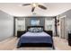 Comfortable main bedroom featuring a ceiling fan, plush carpet, and decorative lamps on the nightstands at 11737 W Robin Dr, Sun City, AZ 85373