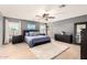 Inviting main bedroom with plush carpet, ceiling fan, and ample natural light from the windows at 11737 W Robin Dr, Sun City, AZ 85373