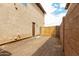 Functional side yard with a gate and access door to the home and block wall at 11737 W Robin Dr, Sun City, AZ 85373