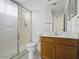 Bathroom featuring a glass shower enclosure and vanity with cabinet storage at 11815 N 75Th Ln, Peoria, AZ 85345